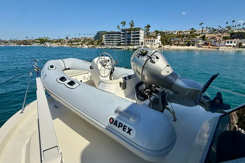 Slide: The Image of 1985 Chris-Craft 382 Commander with Apex inflatable boat on deck, coastal view. - 69