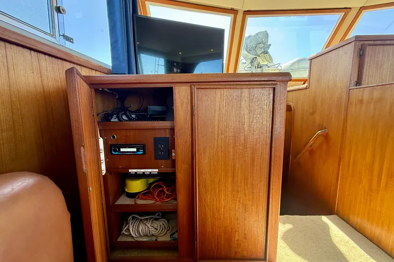 Slide: The Image of Interior of 1985 Chris-Craft 382 Commander with wooden cabinetry and nautical equipment. - 41