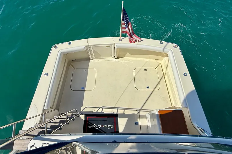 Slide: The Image of 1985 Chris-Craft 382 Commander yacht deck with American flag on turquoise water. - 61