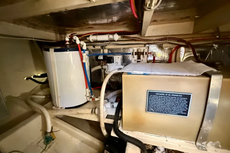 Slide: The Image of Engine room of 1985 Chris-Craft 382 Commander with plumbing and equipment. - 85