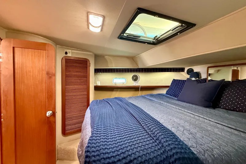 Slide: The Image of 1985 Chris-Craft 382 Commander cabin interior with cozy bed and wooden accents. - 32