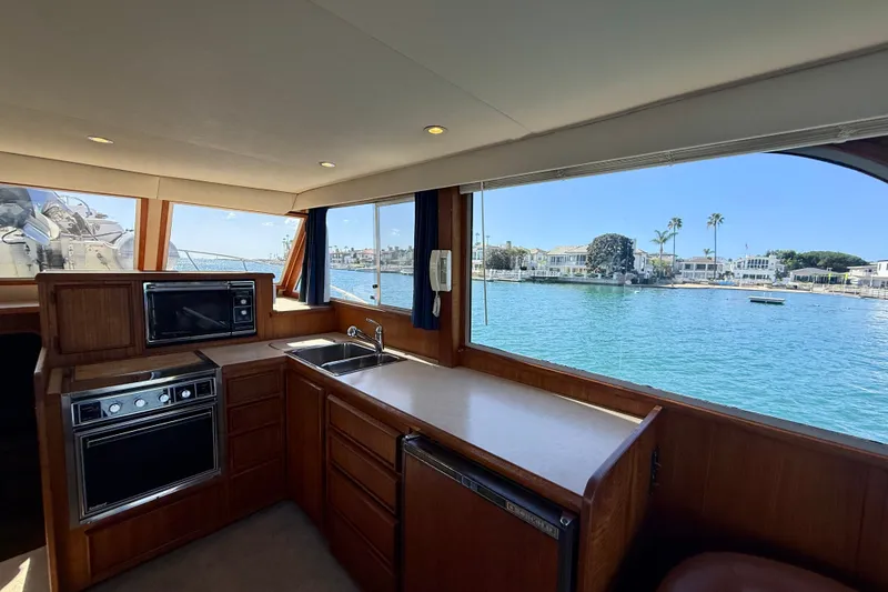 Slide: The Image of Interior of 1985 Chris-Craft 382 Commander yacht with kitchen and waterfront view. - 22