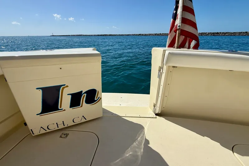 Slide: The Image of 1985 Chris-Craft 382 Commander boat with American flag on open water. - 51