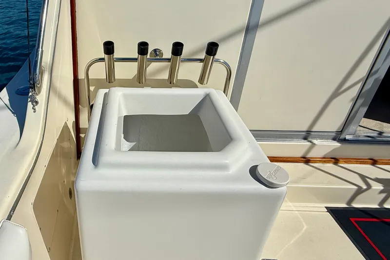 Slide: The Image of Fishing rod holders and storage on 1985 Chris-Craft 382 Commander boat deck. - 53