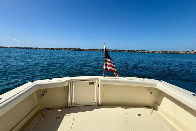 Slide: The Image of 1985 Chris-Craft 382 Commander boat deck with American flag, ocean view. - 48