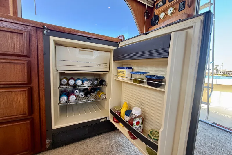 Slide: The Image of Open fridge on 1985 Chris-Craft 382 Commander yacht, stocked with beverages and condiments. - 29