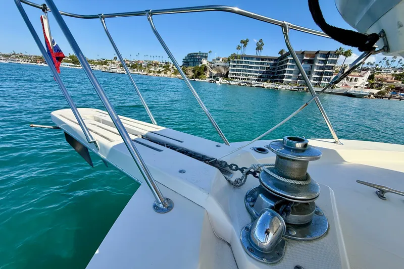 Slide: The Image of 1985 Chris-Craft 382 Commander yacht bow with anchor chain, docked in scenic marina. - 68
