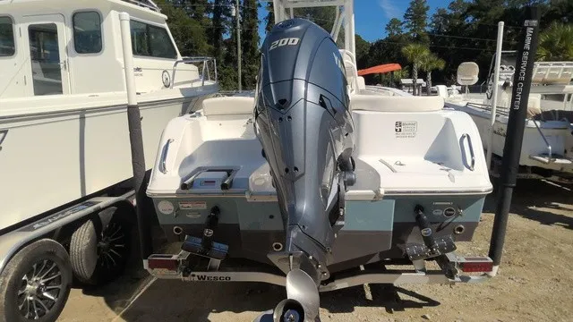 Slide: The Image of The image shows a 2023 Sea Hunt Ultra 229 boat with a 200 HP outboard motor. - 2