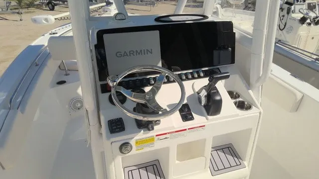 Slide: The Image of The image shows the helm of a Sea Hunt Ultra 229 boat with a Garmin display. - 6