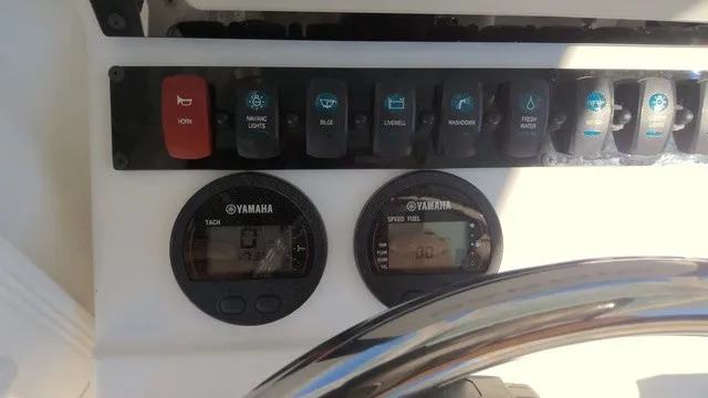 Slide: The Image of The image shows the dashboard of a Sea Hunt Ultra 229 boat with Yamaha instruments. - 7