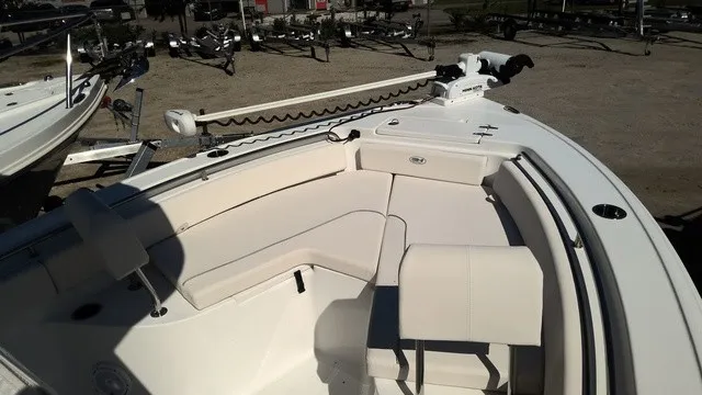 Slide: The Image of The image shows the deck of a 2023 Sea Hunt Ultra 229 boat with white upholstery. - 9