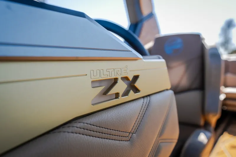 Slide: The Image of 2027 Tigé Ultré 25ZX boat interior with logo detail, showcasing luxury design. - 65