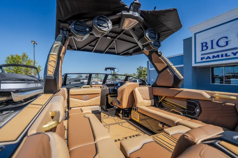 Slide: The Image of 2027 Tigé Ultré 25ZX boat interior with luxurious tan seating and advanced audio system. - 37