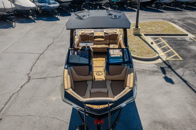 Slide: The Image of 2027 Tigé Ultré 25ZX boat with spacious seating, parked in a lot. - 8