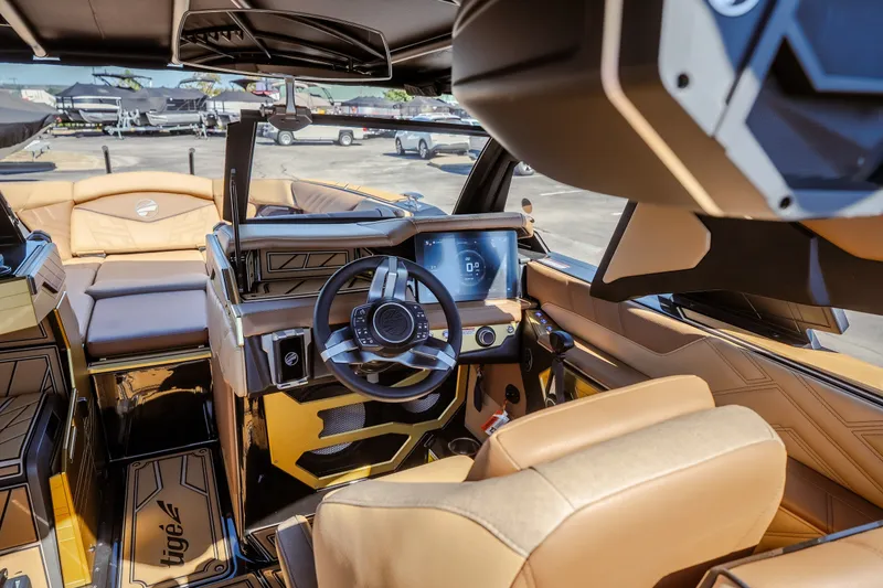 Slide: The Image of 2027 Tigé Ultré 25ZX boat interior with modern dashboard and luxurious seating. - 42