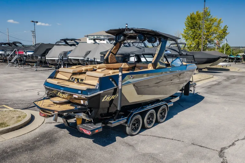 Slide: The Image of 2027 Tigé Ultré 25ZX boat on trailer in marina parking lot, sunny day. - 6