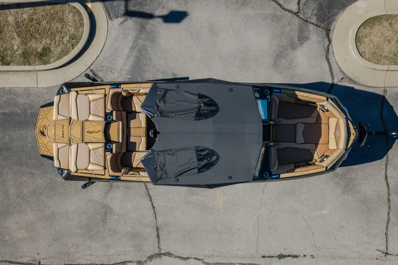 Slide: The Image of Overhead view of 2027 Tigé Ultré 25ZX boat with covered seating and sleek design. - 20