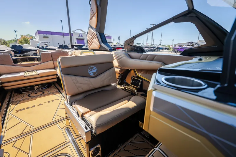 Slide: The Image of Luxurious interior of 2027 Tigé Ultré 25ZX boat with tan leather seating. - 64