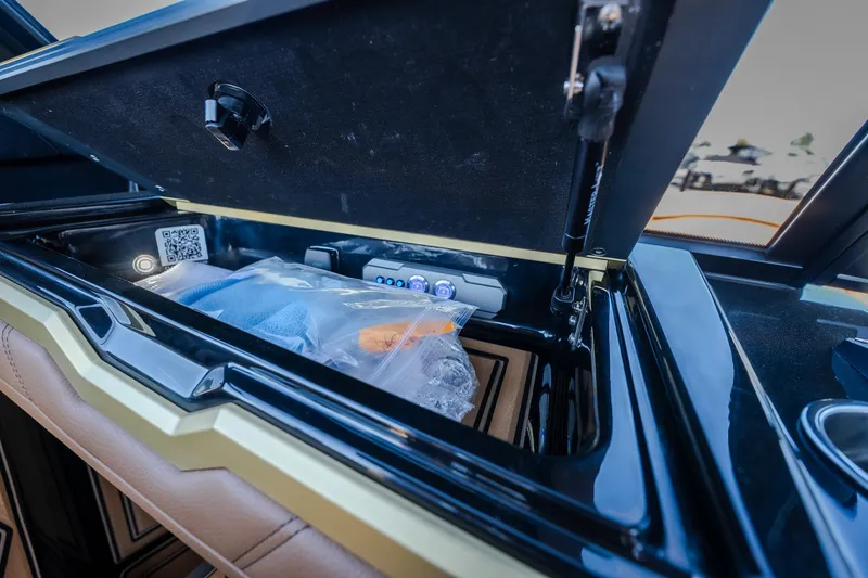 Slide: The Image of Storage compartment in 2027 Tigé Ultré 25ZX boat, featuring organized interior and QR code. - 15