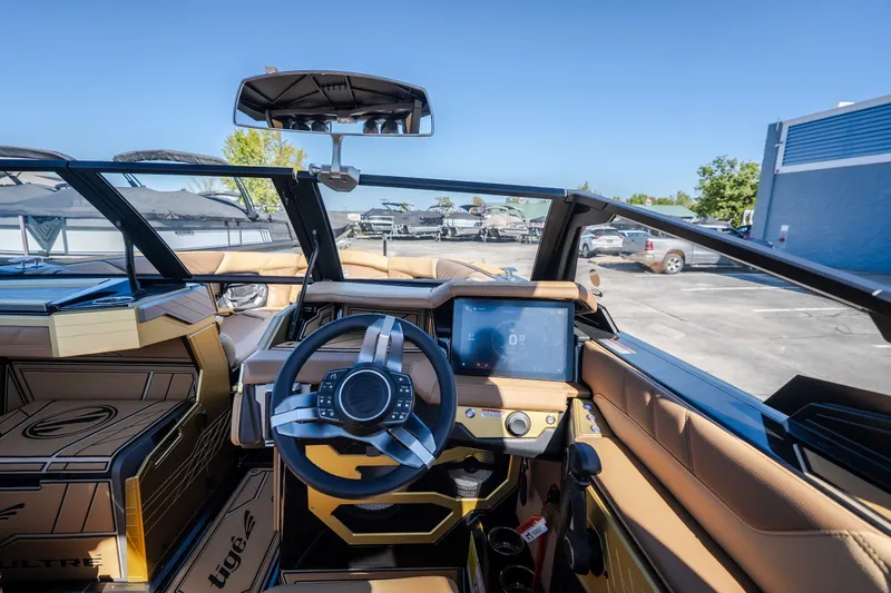 Slide: The Image of 2027 Tigé Ultré 25ZX boat interior with modern steering and touchscreen display. - 49