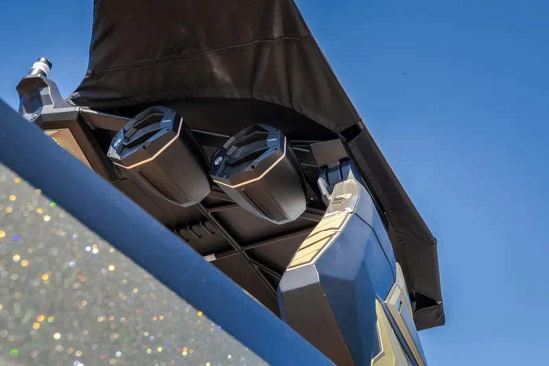 Slide: The Image of 2027 Tigé Ultré 25ZX boat speakers under canopy against clear blue sky. - 25
