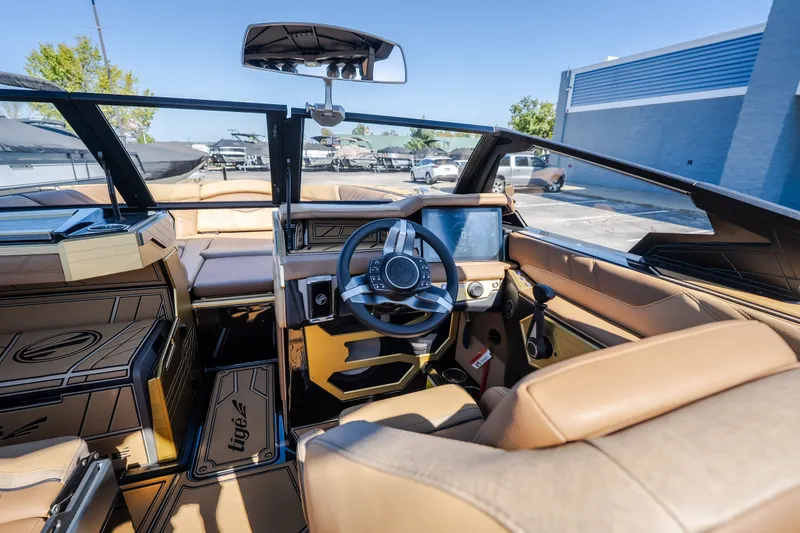 Slide: The Image of Interior of 2027 Tigé Ultré 25ZX boat with modern dashboard and luxurious seating. - 44