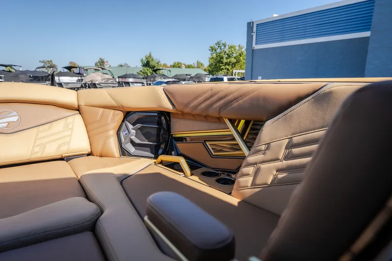 Slide: The Image of Luxurious interior of 2027 Tigé Ultré 25ZX boat with tan leather seating. - 58