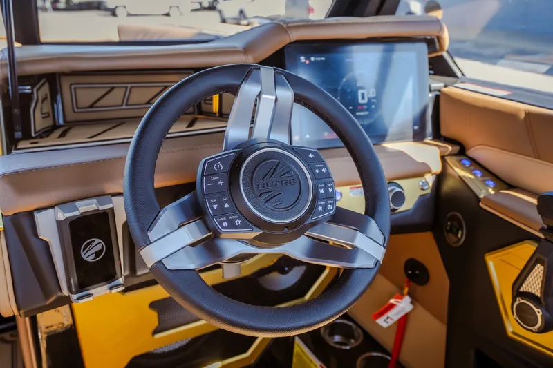 Slide: The Image of 2027 Tigé Ultré 25ZX steering wheel and dashboard with modern controls and touchscreen display. - 45
