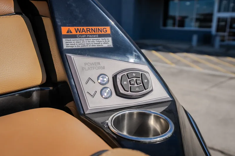 Slide: The Image of Control panel of 2027 Tigé Ultré 25ZX boat with warning label and cup holder. - 31
