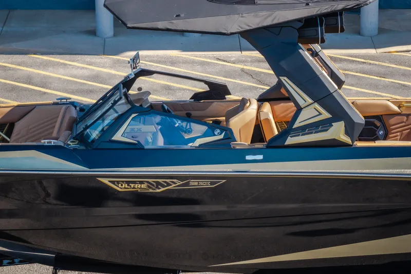 Slide: The Image of 2027 Tigé Ultré 25ZX boat with sleek design and modern features, docked outdoors. - 10