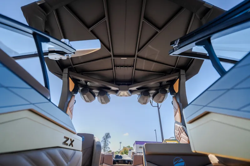 Slide: The Image of 2027 Tigé Ultré 25ZX boat interior with speakers and sleek design. - 16
