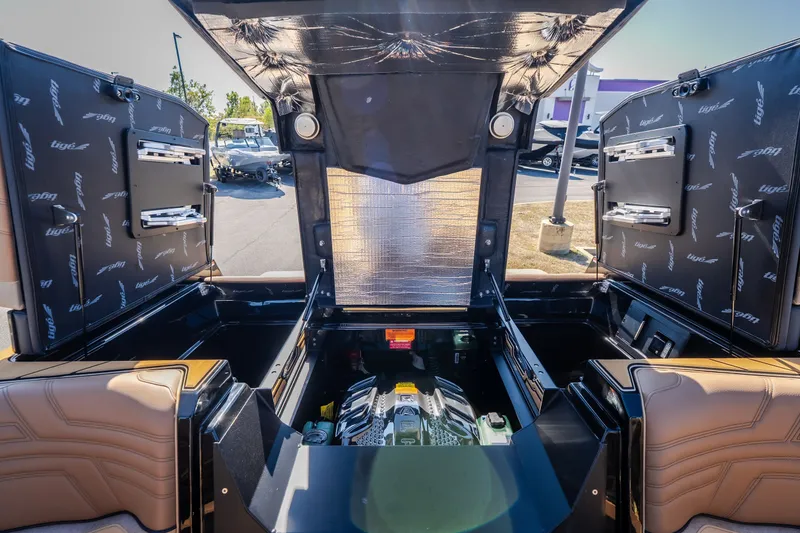 Slide: The Image of 2027 Tigé Ultré 25ZX boat engine compartment with open hatches, showcasing interior details. - 17