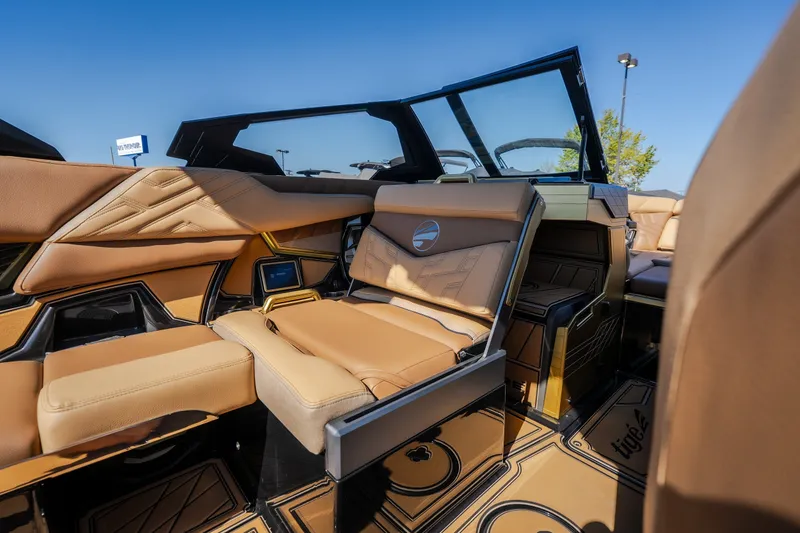 Slide: The Image of Luxurious interior of 2027 Tigé Ultré 25ZX boat with tan leather seating. - 54
