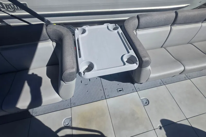 Slide: The Image of 2023 Sea-Doo Switch Cruise 21 interior with gray seating and a central table. - 7