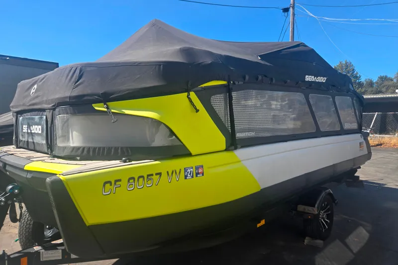 Slide: The Image of 2023 Sea-Doo Switch Cruise 21 with cover, parked outdoors on a sunny day. - 4