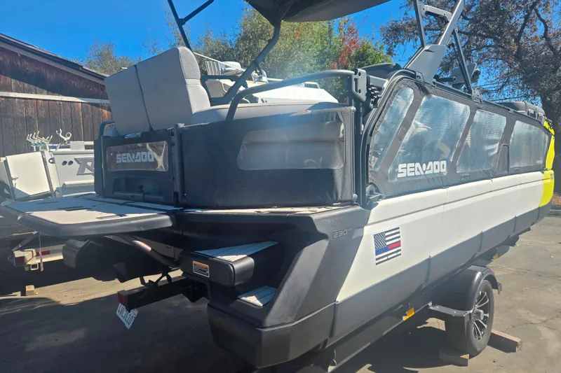 Slide: The Image of 2023 Sea-Doo Switch Cruise 21 pontoon boat on trailer, rear view. - 3