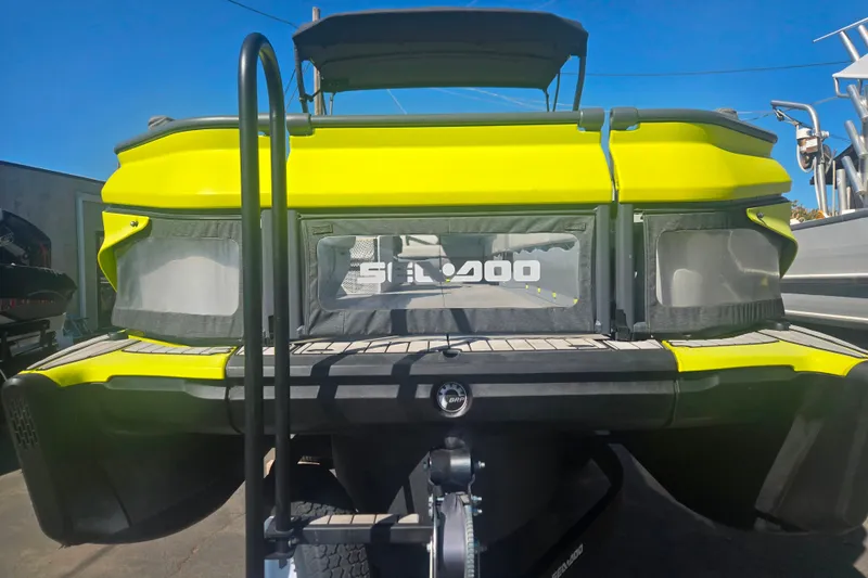 Slide: The Image of 2023 Sea-Doo Switch Cruise 21, vibrant yellow rear view, parked outdoors. - 13