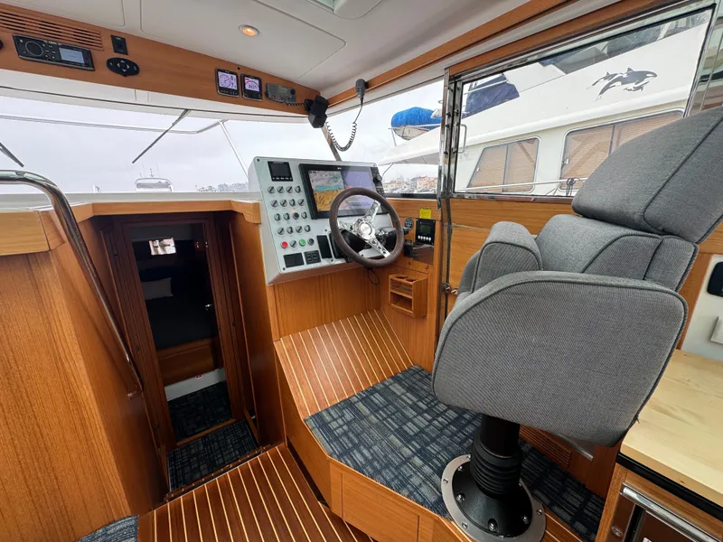 Slide: The Image of The image shows the cockpit of a 2013 Delta Powerboats 40 Walk Around with a modern helm station. - 34