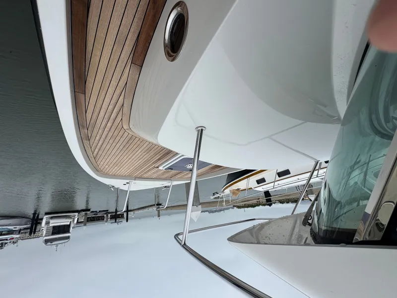 Slide: The Image of The image shows the deck of a 2013 Delta Powerboats 40 Walk Around with wood paneling. - 18