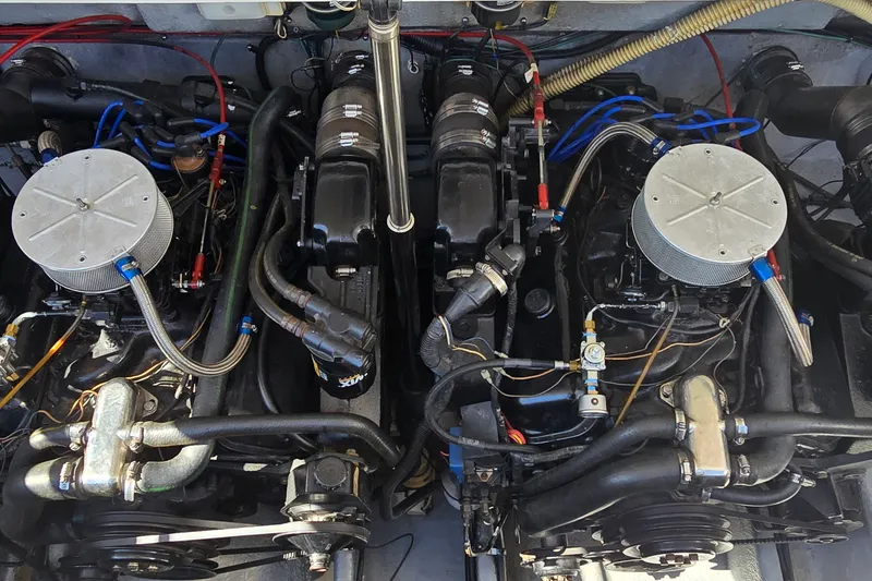 Slide: The Image of Twin engines of a 1992 Sea Ray 380 Sun Sport boat, showcasing detailed components. - 30