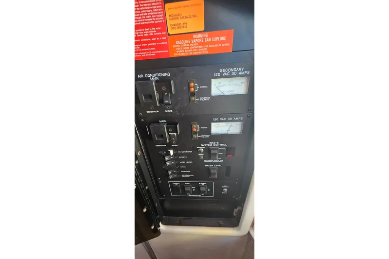 Slide: The Image of Control panel of a 1992 Sea Ray 380 Sun Sport boat, featuring various switches and gauges. - 34