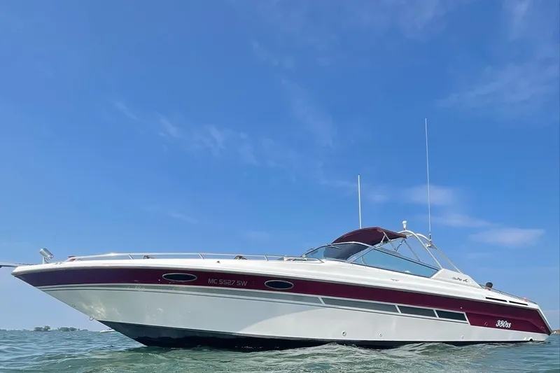 The Image of 1992 Sea Ray 380 Sun Sport boat on water under clear blue sky. - 0