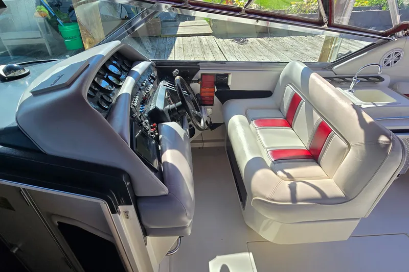 Slide: The Image of 1992 Sea Ray 380 Sun Sport cockpit with steering wheel and cushioned seating. - 14