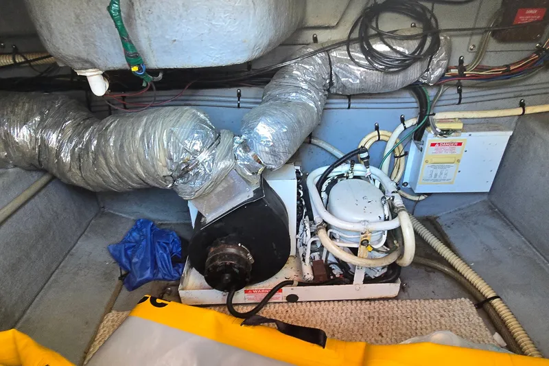 Slide: The Image of Engine room of 1992 Sea Ray 380 Sun Sport with visible ductwork and machinery. - 26