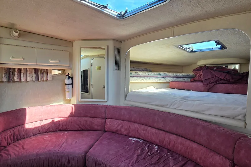 Slide: The Image of Interior of 1992 Sea Ray 380 Sun Sport with pink seating and sleeping area. - 19