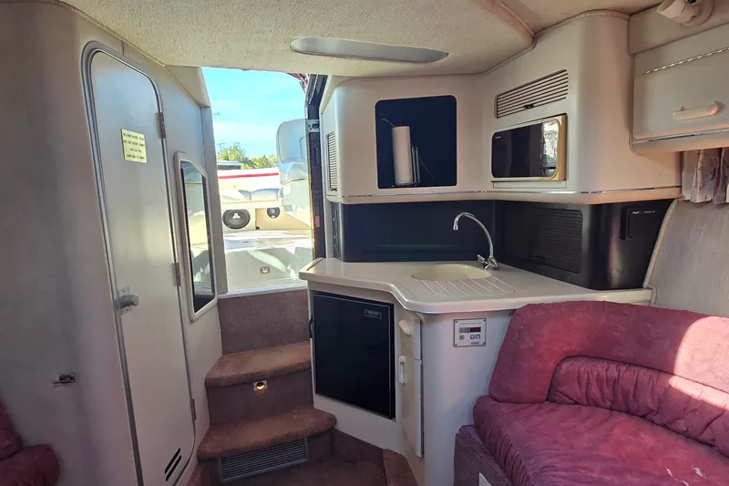 Slide: The Image of Interior of 1992 Sea Ray 380 Sun Sport with kitchenette and seating area. - 23