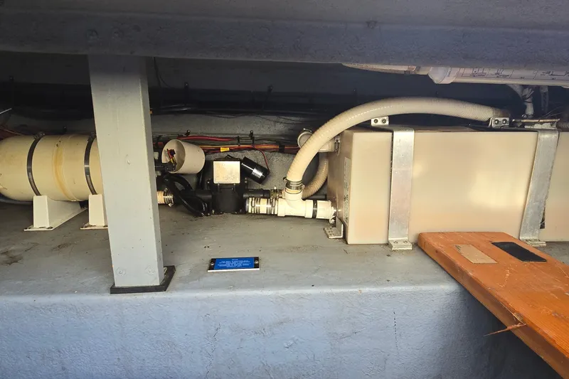 Slide: The Image of Engine compartment of a 1992 Sea Ray 380 Sun Sport boat, showing mechanical components and wiring. - 25