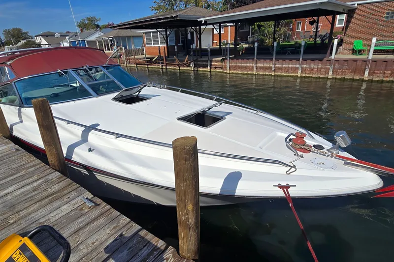 The Image of 1992 Sea Ray 380 Sun Sport docked by waterfront homes. - 1