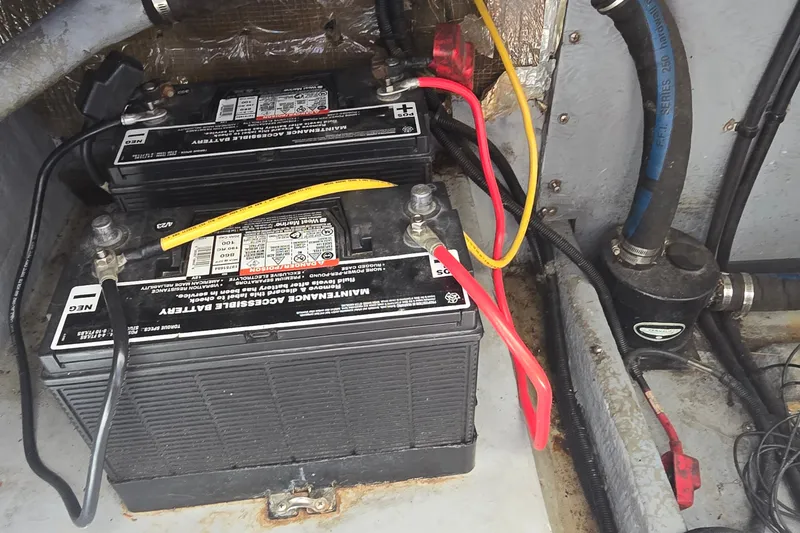 Slide: The Image of Battery compartment of a 1992 Sea Ray 380 Sun Sport boat with connected cables. - 31