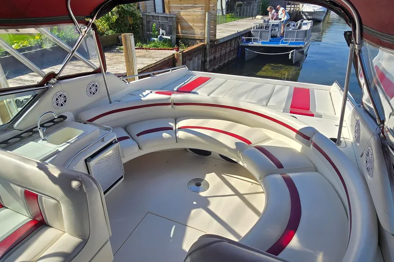 Slide: The Image of Luxurious 1992 Sea Ray 380 Sun Sport boat interior with curved seating and dock view. - 15